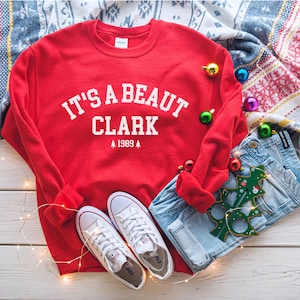 Sudadera "It's a Beaut" de Clark, sudadera navideña divertida, sudadera con regalo navideño festivo, sudadera de Clark Griswold, sudadera navideña de cuello redondo