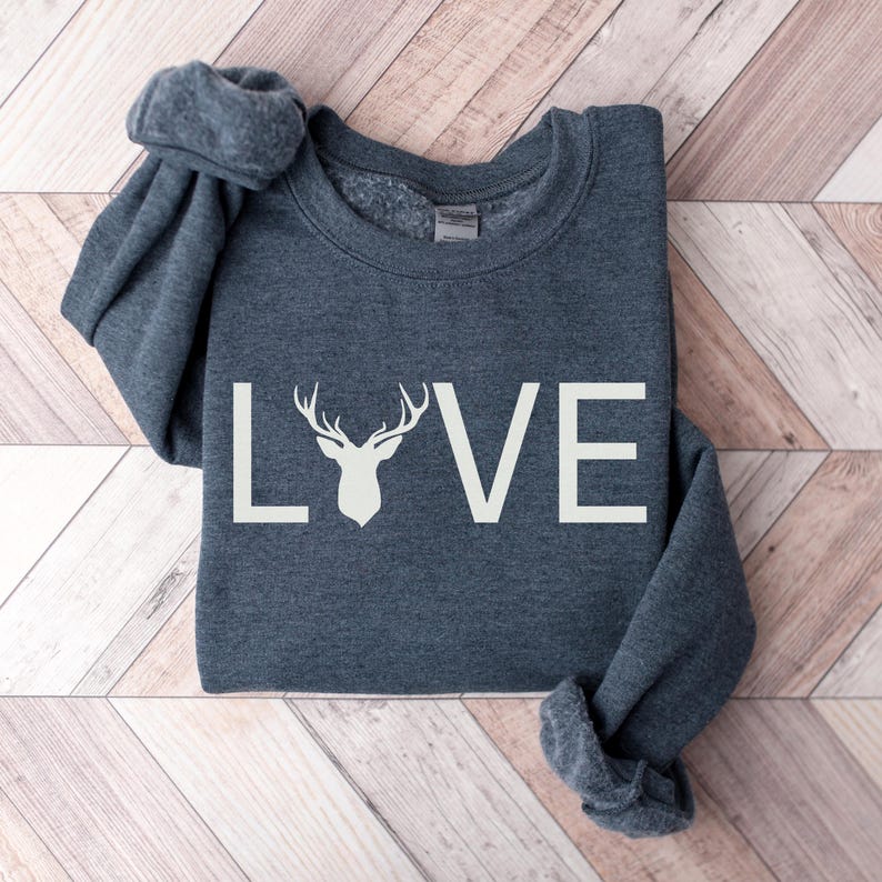May include: A dark gray sweatshirt with a white graphic of a deer head and the word "LOVE" printed on the front.