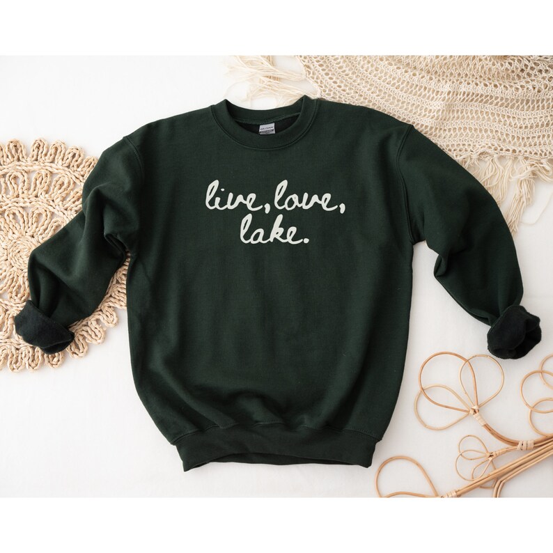 May include: A dark green sweatshirt with the text "live, love, lake." printed in white on the front.