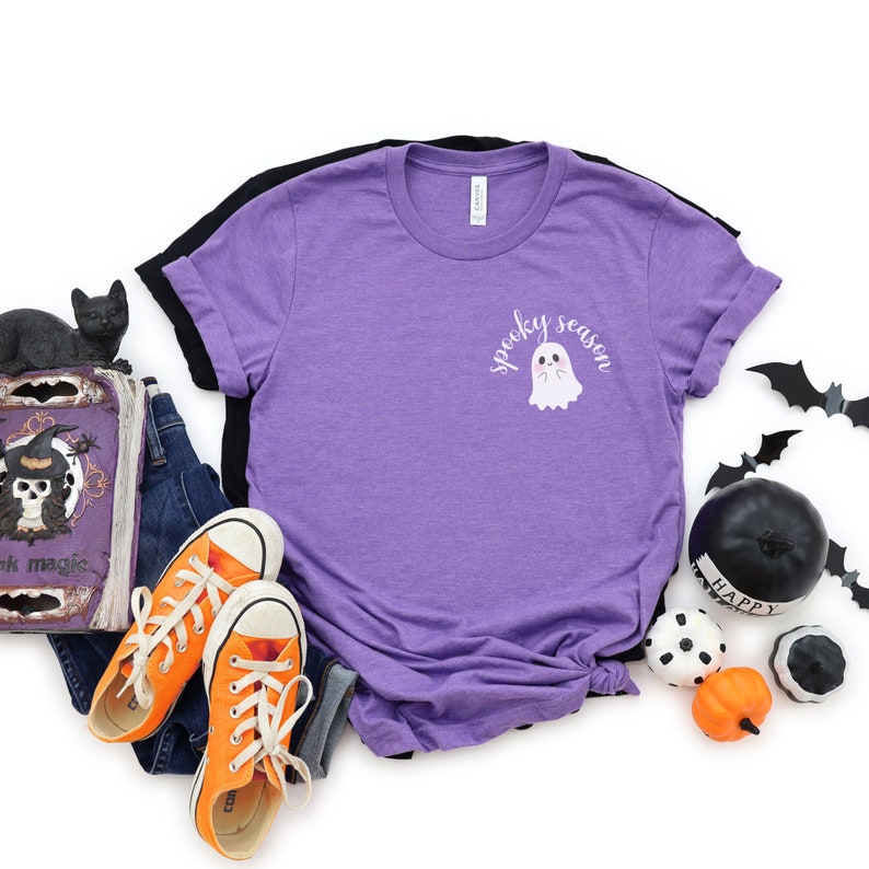 May include: Purple t-shirt with a white ghost graphic and the text "spooky season".