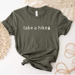 May include: A green t-shirt with the text "take a hike" and a small pine tree graphic in white.