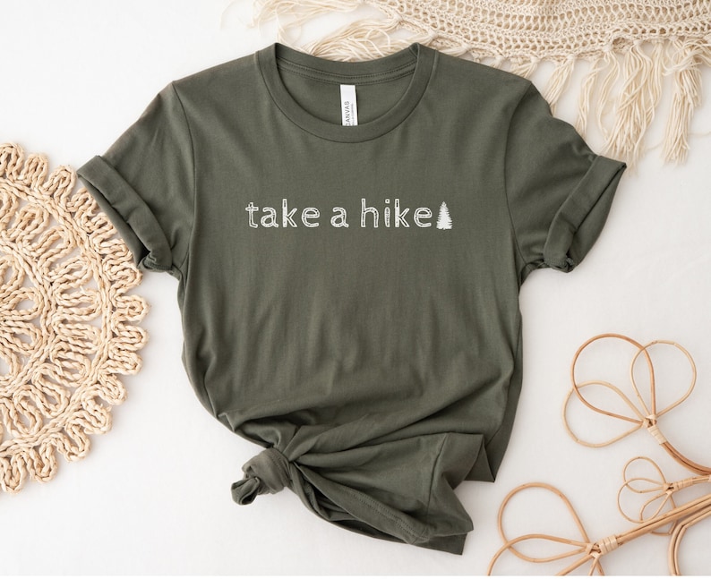 May include: A green t-shirt with the text "take a hike" and a small pine tree graphic in white.