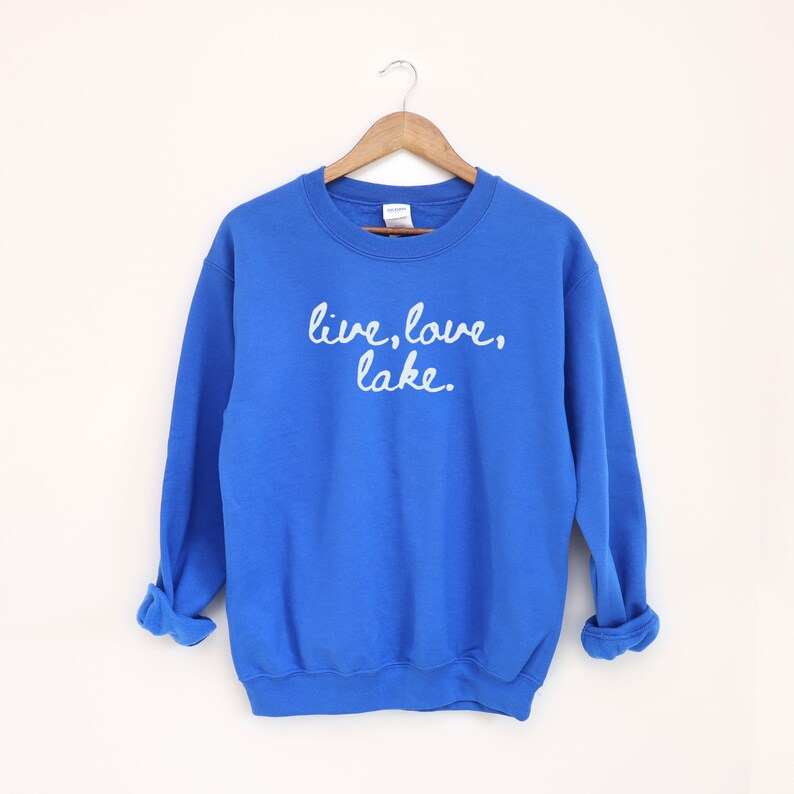 May include: Royal blue sweatshirt with the text "live, love, lake." in white cursive lettering.