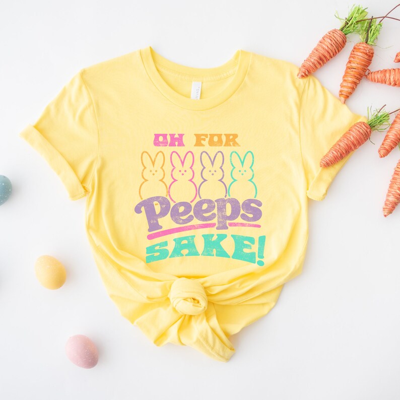 May include: Yellow t-shirt with a graphic of four pastel-colored Peeps and the text "Oh for Peeps Sake!"