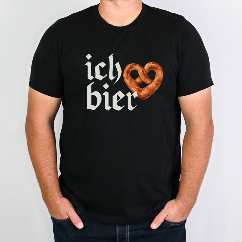 Op de afbeelding: Zwart T-shirt met een witte afbeelding van een hartvormige pretzel en de tekst "ich &hearts; bier".
