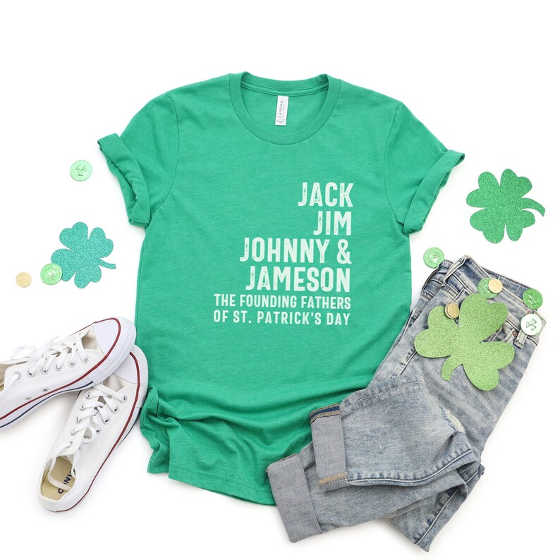 May include: Green t-shirt with white text that reads "Jack Jim Johnny & Jameson The Founding Fathers of St. Patrick's Day".