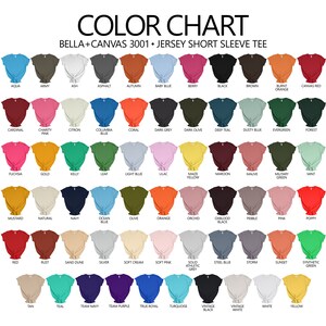 May include: Color chart showing 48 different colors of Bella + Canvas 3001 Jersey Short Sleeve Tees. The colors are arranged in rows and columns, with each color represented by a folded t-shirt.