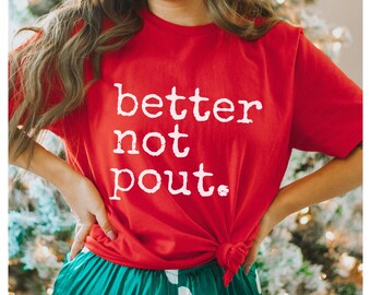 May include: Red t-shirt with white text that reads "better not pout."