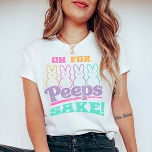 May include: White t-shirt with a graphic of four pastel-colored Peeps and the text "Oh for Peeps Sake!"