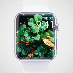 May include: A white smartwatch with a silver bezel and a green four-leaf clover wallpaper. The time is 9:41 and the date is TUE 12.