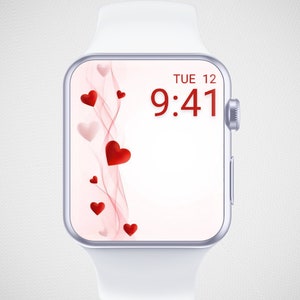 May include: A white smartwatch with a pink and white background on the screen. The screen displays the time 9:41 and the date TUE 12. There are red hearts scattered on the screen.