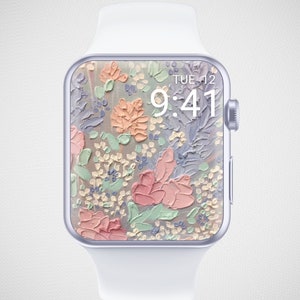 Może przedstawiać: Biały zegarek Apple Watch z kwiatowym cyferblatem. Tarcza zegarka przedstawia malowany wz&oacute;r kwiat&oacute;w w odcieniach r&oacute;żowego, brzoskwiniowego, zielonego i fioletowego. Godzina jest wyświetlana jako 9:41, a dzień jako WTO 12.