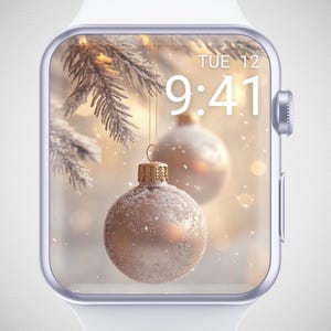 May include: A white smartwatch with a Christmas-themed display. The screen shows two gold baubles suspended from a snow-covered pine branch. The time is 9:41 AM on Tuesday, December 12th. The watch has a silver bezel and a white strap.