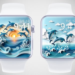 Op de afbeelding: Twee witte smartwatches met wijzerplaten met dolfijnenthema. Eén heeft een zonsondergangscène met dolfijnen die uit de golven springen. De andere toont dolfijnen die springen tegen een blauwe lucht met wolken. Beide tonen de tijd als 9:41 en de dag als Di 12.
