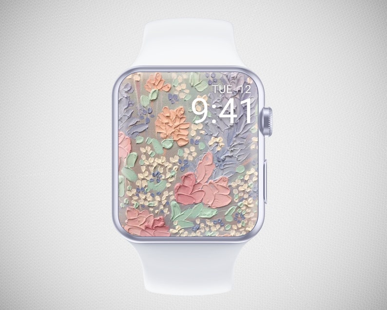 Może przedstawiać: Biały zegarek Apple Watch z kwiatowym cyferblatem. Tarcza zegarka przedstawia malowany wz&oacute;r kwiat&oacute;w w odcieniach r&oacute;żowego, brzoskwiniowego, zielonego i fioletowego. Godzina jest wyświetlana jako 9:41, a dzień jako WTO 12.