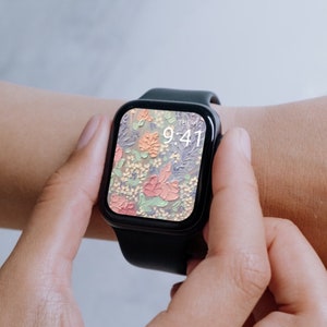 Może przedstawiać: Czarny smartwatch z kwiatowym cyferblatem. Godzina 9:41. Zegarek jest na nadgarstku osoby.