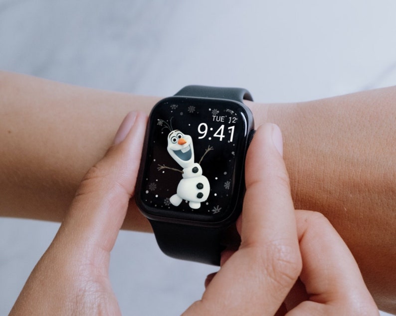 May include: A black smartwatch displaying a cartoon image of Olaf from Frozen. The watch face shows the time as 9:41 and the day as Tuesday. The watch is on a black band.