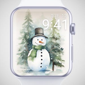 May include: A digital watch face displays a watercolor snowman wearing a black top hat and green scarf, set against a backdrop of evergreen trees. The time is 9:41, and the date is Tuesday the 12th.
