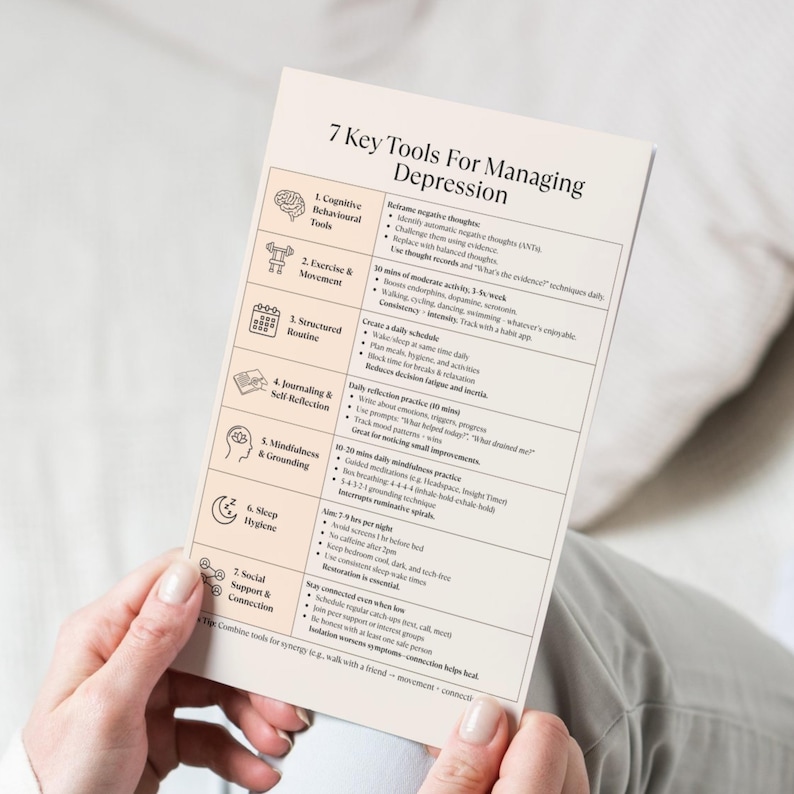 Mood support depression worksheet held in hands over white bedding, printable mental health resource for self-care and healing.