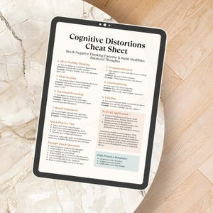 May include: A digital tablet shows a "Cognitive Distortions Cheat Sheet" detailing negative thinking patterns and healthier thought processes. The white tablet with a black border sits on a light, patterned surface, offering self-help guidance.