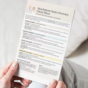 Casual lifestyle mockup of the Attachment Styles Overview Cheat Sheet being held by a person, highlighting the clean and easy-to-read layout.