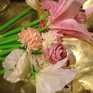 May include: A collection of pens topped with artificial flowers in various shades of pink, white, and peach. Each pen features a bright green stem-like barrel and a realistic fabric floral bloom attached to the top, creating a bouquet-like appearance.