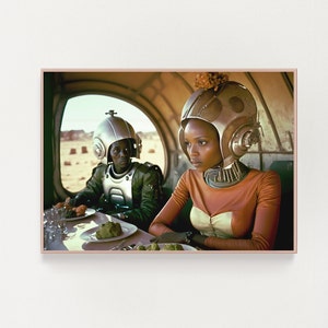 May include: Two people wearing futuristic helmets sit at a table in a spaceship-like setting. The person on the left is wearing a green and silver helmet and a green jumpsuit. The person on the right is wearing a brown and silver helmet and a brown and white jumpsuit. They are both looking at the camera.