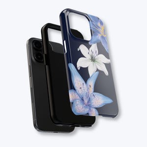 May include: A black smartphone with a protective case featuring a floral design. The case has a dark blue background with watercolor-style blue and white lilies. The phone and case are displayed against a light background.