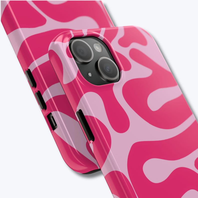 May include: Two pink phone cases with a wavy, abstract pattern in shades of light and hot pink. The cases have black side buttons and camera cutouts. The design is repeated on both cases, with one slightly behind the other.