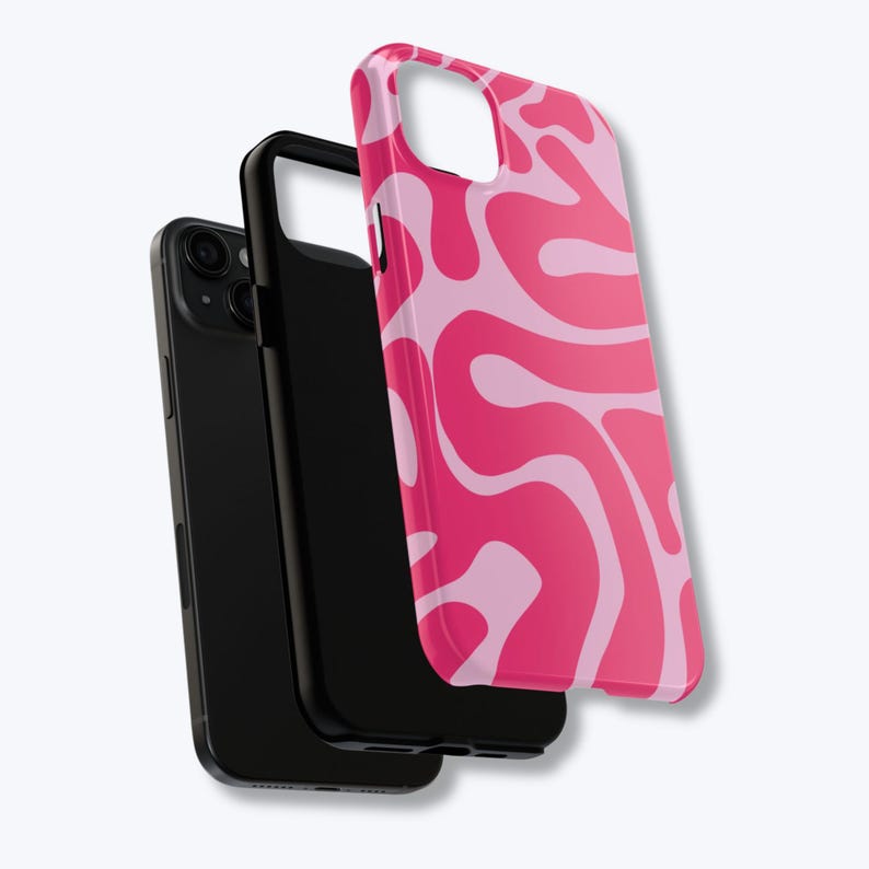 May include: A black phone with a black case and a pink and light pink swirled phone case. The phone case has a glossy finish and a unique, abstract design. The phone and cases are displayed against a white background.