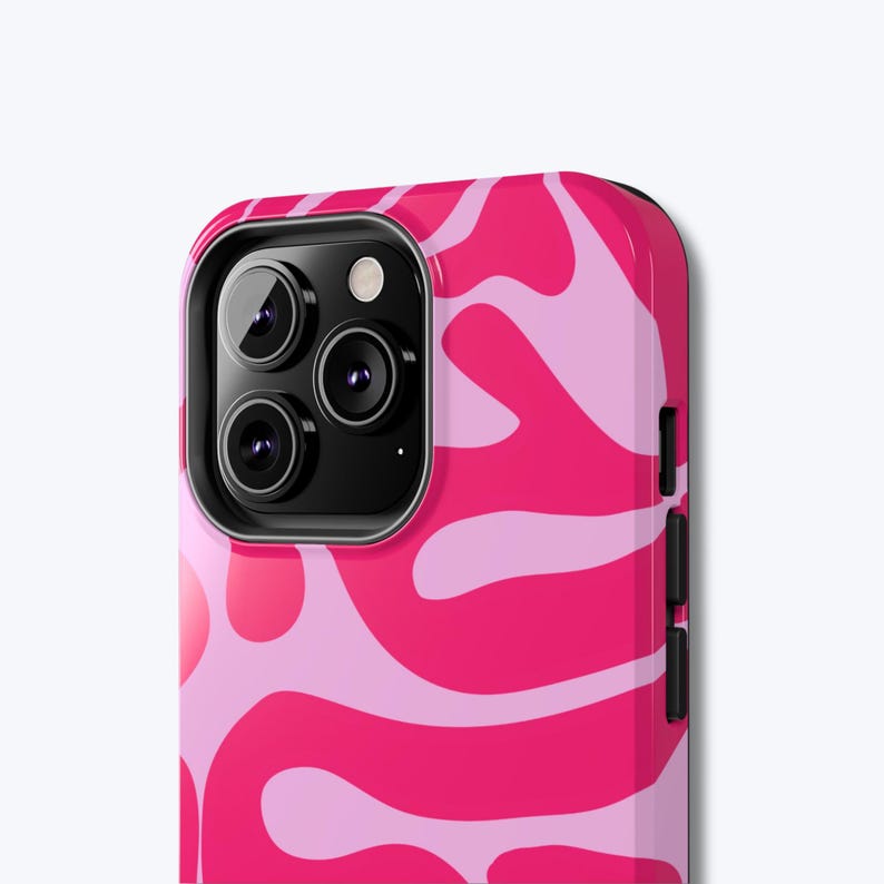 May include: A vibrant pink and light pink patterned phone case. The case features a swirling, abstract design. The phone case has a black camera module with three lenses and a flash. The case is designed to fit a smartphone.
