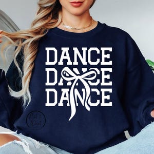 May include: Navy blue sweatshirt with the words "Dance Dance Dance" in white text and a white bow graphic.