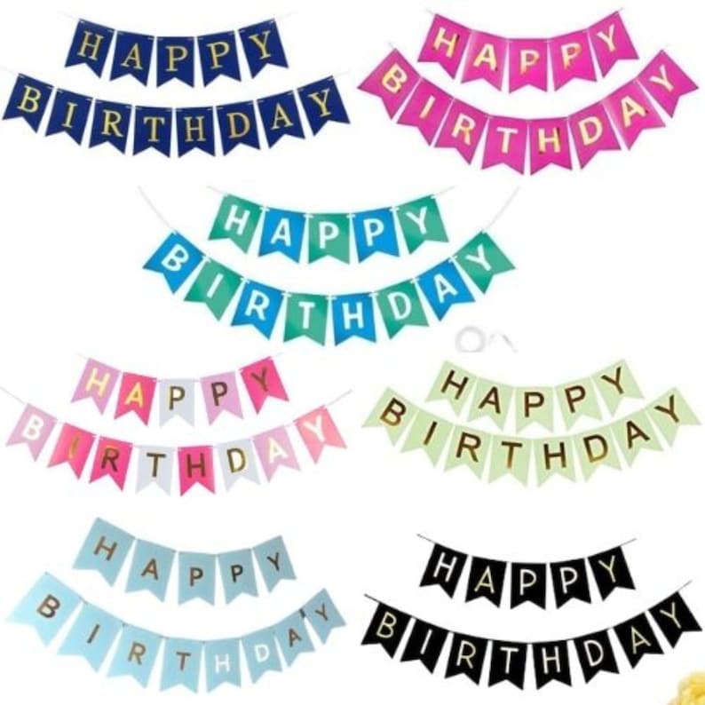 May include: A collection of colorful "Happy Birthday" banner flags in various colors, including blue, pink, green, and black. Each banner has gold lettering and is strung on a white string, perfect for birthday party decorations.