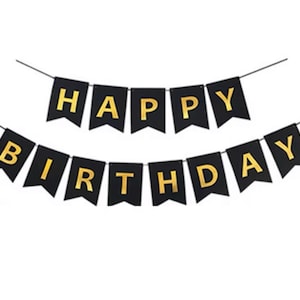 May include: Black banner with gold letters spelling "HAPPY BIRTHDAY". The banner is strung on a thin black string. The letters are in a bold, sans-serif font, creating a festive and celebratory feel.