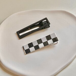 Chic hairpin featuring a classic checkered pattern, a timeless addition to elevate your style