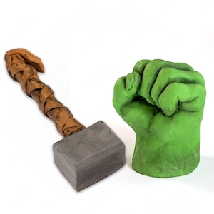 May include: A green Hulk fist and a brown and grey Thor's hammer.