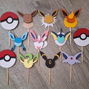 May include: A set of 12 Pokemon character cake toppers. The toppers are made of cardstock and feature various Pokemon characters, including Pikachu, Eevee, and Charmander. The toppers are perfect for adding a fun and festive touch to any Pokemon-themed party.