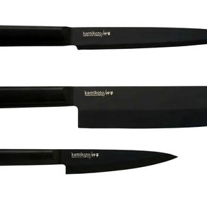 May include: Three black kitchen knives with matching black handles are displayed against a white background. The knives include a paring knife, a chef's knife, and a cleaver. The brand name "kamikoto" is printed on the blades.