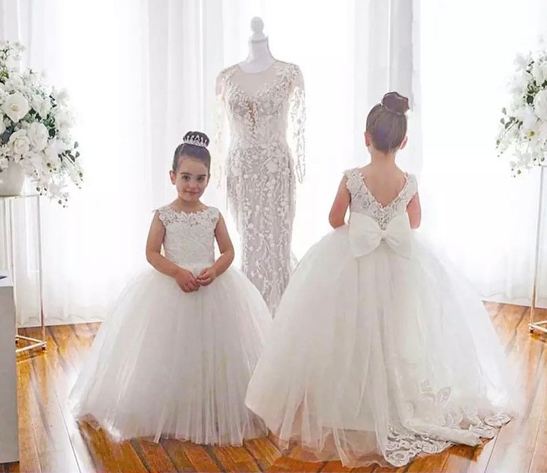 Flower girl holy communion ivory lace dresses with a flowing train to the back princess dress beautiful lace to the front image 1