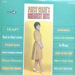 May include: A green and yellow vinyl record cover with a photo of Patsy Cline. The title of the record is "Patsy Cline's Greatest Hits". The record cover lists the songs "Crazy", "Back In Baby's Arms", "Faded Love", "You're Stronger Than Me", "Sweet Dreams", "Walking After Midnight", "Strange", "I Fall To Pieces", "So Wrong", "Leavin' On Your Mind", "She's Got You", and "Why Can't He Be You".