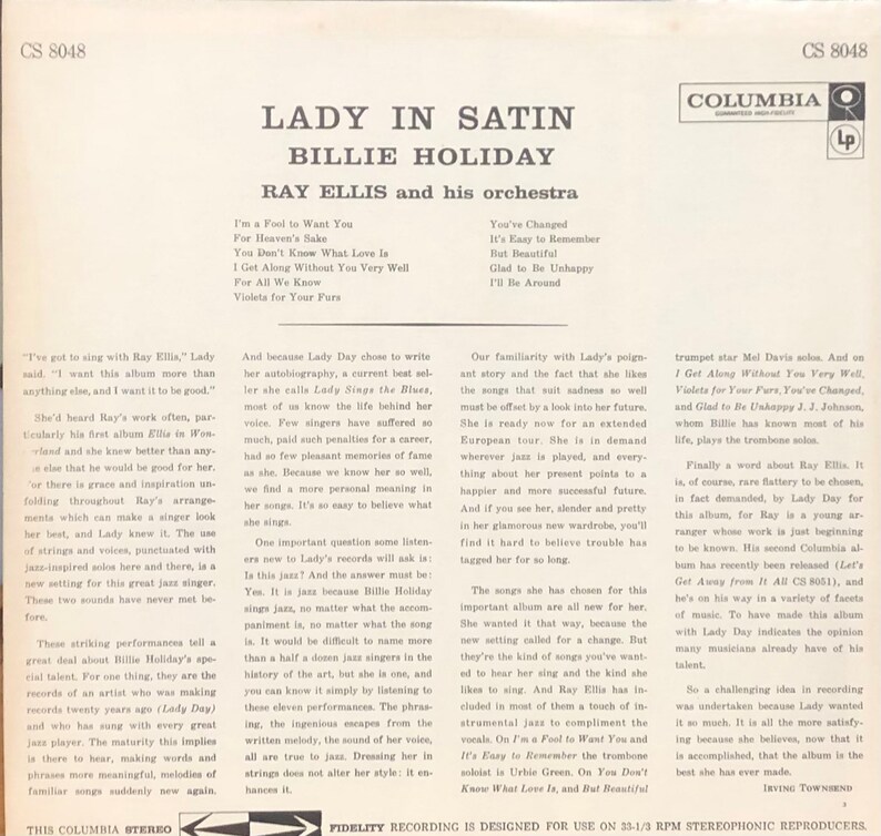 Op de afbeelding: Een zwart-witte platenhoes met een foto van Billie Holiday in een satijnen jurk. De titel van het album is "Lady in Satin" en bevat de tekst "Ray Ellis en zijn orkest".