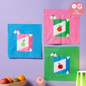 May include: Three fabric squares with different colored backgrounds and fruit designs. The squares are made using a paper piecing technique. The background colors are blue, pink, and green. The fruits are a pear, an apple, and an orange. The text "TO LOVE PDF PATTERN" is in a pink circle with a needle and thread icon.