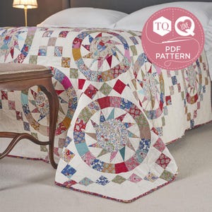 May include: A quilt featuring a repeating star pattern with circular borders in various floral prints and colors, set against a cream background. A circular pink badge with the text TQ LOVE PDF PATTERN is visible in the upper right corner.