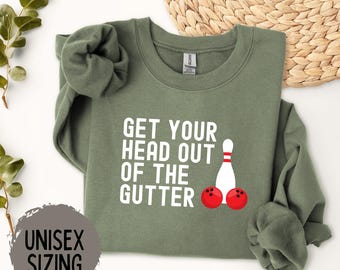 May include: A green sweatshirt with the text "Get your head out of the gutter" and a bowling pin and bowling balls graphic. The sweatshirt is unisex sizing.