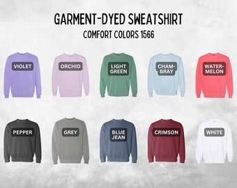 May include: A display of ten garment-dyed sweatshirts in various colors, including violet, orchid, light green, chambray, watermelon, pepper, grey, blue jean, crimson, and white. The text "GARMENT-DYED SWEATSHIRT" and "COMFORT COLORS 1566" are at the top.