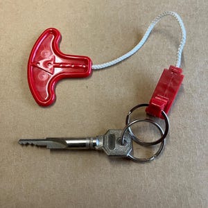 Keychain, life jacket, keychain made from an authentic life vest inflation pull. image 1