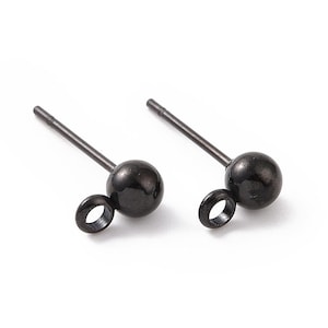May include: A pair of black stud earrings with a small loop on the side. The earrings are made of metal and have a smooth, polished finish.