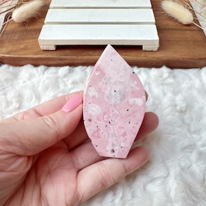 May include: A pink and white marbled leaf-shaped soap bar.