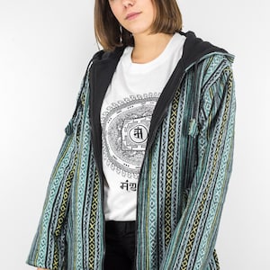 May include: A teal, black, and yellow striped hooded jacket with a zipper closure. The jacket has a mandala design and the word "मंगल" printed on the front.
