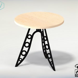 May include: A round wooden table top with a black metal base featuring a unique design of circles and curves. The table is approximately 20 inches in diameter.